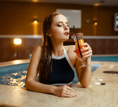 sexy-lady-drinks-fruit-cocktail-pool-side-indoors-swimming